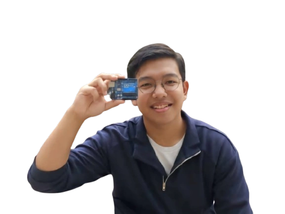 Kika smiling and holding an Arduino Uno